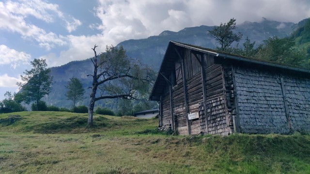 Alphütte am Wegesrand. Kleines antikes Schild mit dem Aufdruck 