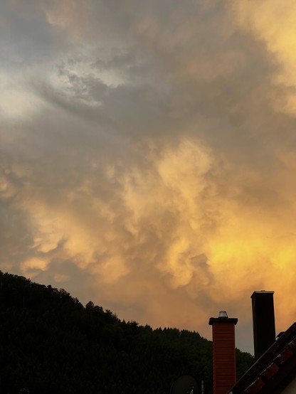 Wolken im Morgenlicht, man sieht einen einzelnen „Tropfen“, der an Mammatus erinnert. 